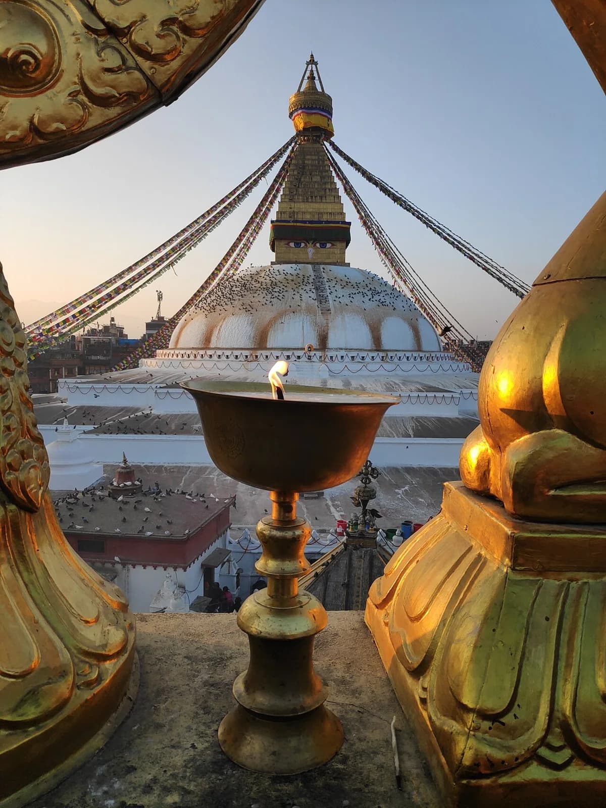 Butter lamps beside the stupa