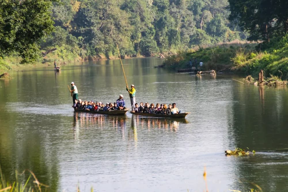 Visitors canoeing along the river near Sauraha in Chitwan